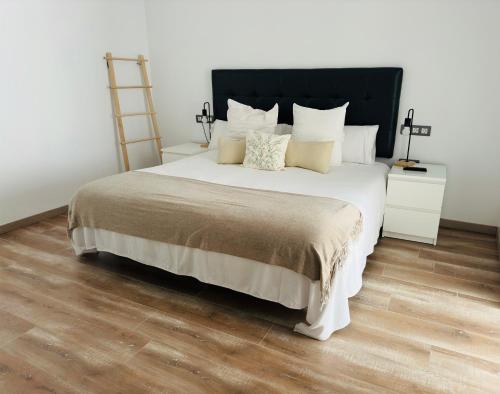 a bedroom with a large bed and a wooden floor at Mater Ariany in Ariany