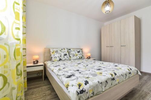 a small bedroom with a bed and a dresser at Apartment Gordana Mar in Vrsi