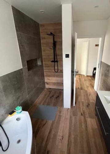a bathroom with a shower and a toilet and a sink at Ferienwohnung in Bad Laasphe
