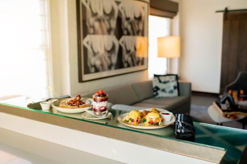 a buffet with two plates of food on a table at Andaz San Diego, By Hyatt in San Diego