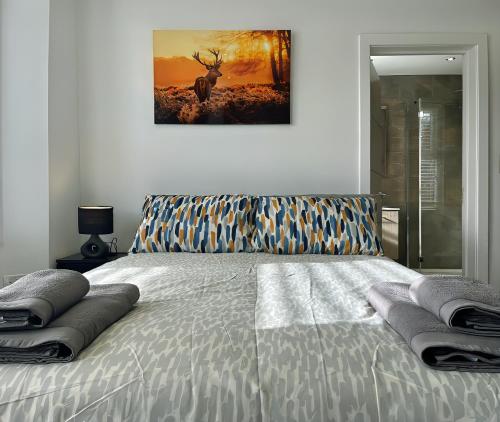 a bedroom with a bed with a painting on the wall at Shelbourne Den in Bournemouth