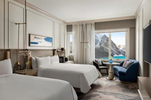 a hotel room with two beds and a window at Fairmont Château Lake Louise in Lake Louise