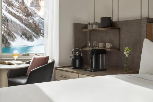 a hotel room with a coffee maker and a table at Fairmont Château Lake Louise in Lake Louise