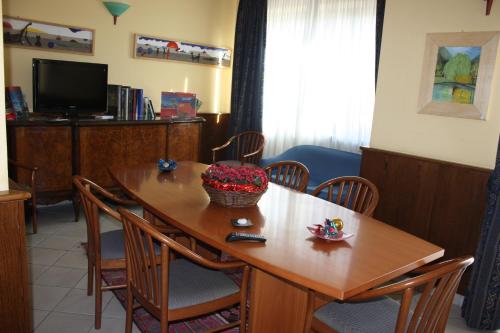 a dining room table with a basket of flowers on it at Hotel Tre Denti in Cantalupa