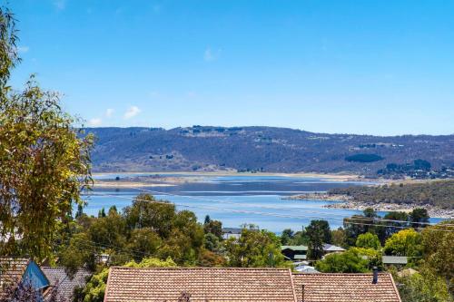 a view of a river with trees and houses at Snowbird 1 - Charming 2BR Townhouse l Lake Views l Air-Con l Off-Street Parking in Jindabyne