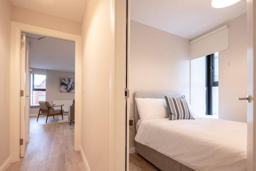a bedroom with a bed and a sliding glass door at 3rd Floor Stylish 2-Bed Apartment in Drogheda