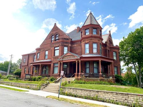 a large red brick building with a tower at Vineyard Mansion B&B in Saint Joseph