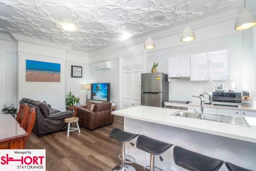 a kitchen and living room with a counter top at King & Queen Bed - Apartment on Summer Near Cook Park in Orange