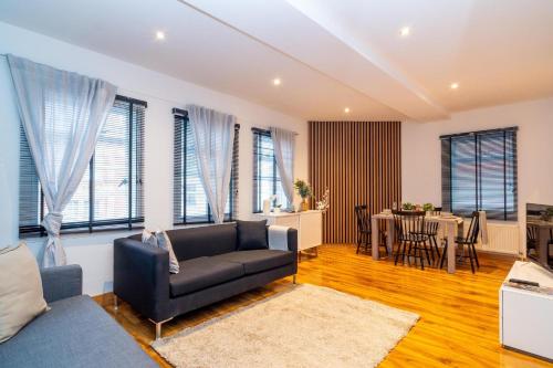 a living room with a couch and a table at Buckingham Suite - Heart of Covent Garden! in London