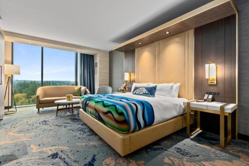 a hotel room with a large bed and a desk at Muckleshoot Casino Resort in Auburn