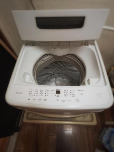 a close up of a washing machine in a room at Zamami Chura Dreamz in Zamami