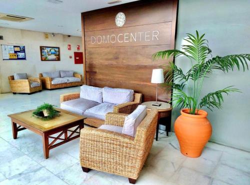 a living room with a couch and a table at ApartHome Domocenter in Bormujos
