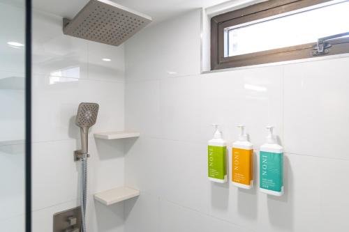 a bathroom with three shampoo bottles on a shelf at Waikiki Banyan Fabulous Ocean View Condo with Free Parking in Honolulu