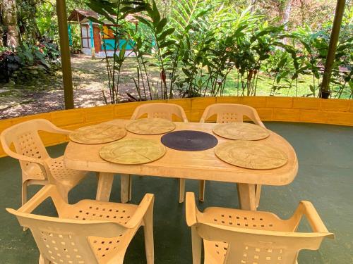a wooden table with four chairs around it at Habitación grupal en San Carlos con acceso al rio y desayuno incluido in San Carlos