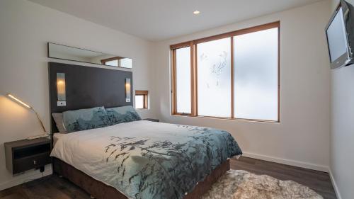 a bedroom with a bed and a large window at Absollut 4 in Mount Hotham