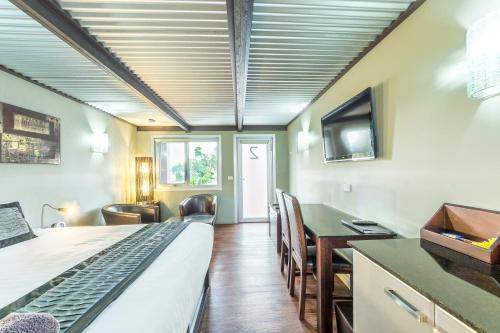 a room with a bed and a desk and a television at Orbost Motel in Orbost