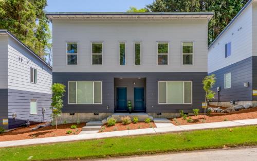 a white house with blue doors and trees at Harbor Lights 3 New 2024, Hot Tub, Pet OK in Depoe Bay