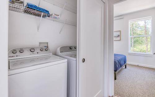 a white laundry room with a washer and dryer at Harbor Lights 3 New 2024, Hot Tub, Pet OK in Depoe Bay