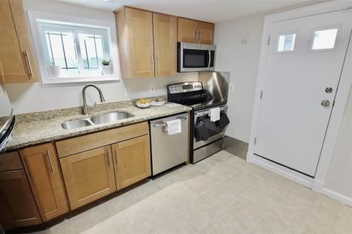 a kitchen with a sink and a stove and a microwave at Top of the Town - with Parking in Washington, D.C.