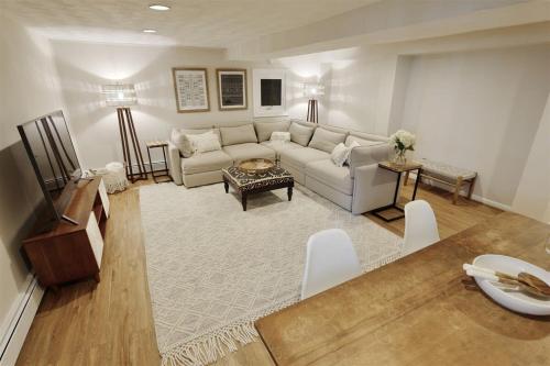 a living room with a couch and a table at Top of the Town - with Parking in Washington, D.C.