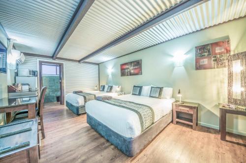 a hotel room with two beds and a television at Orbost Motel in Orbost