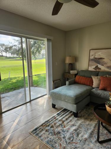 a living room with a couch and a sliding glass door at D&T Flamingo Paradise in Haines City