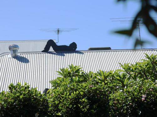 a person laying on the side of a building at Haven on the Park in Perth