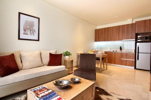 a living room with a couch and a kitchen at Dwijaya House of Pakubuwono in Jakarta