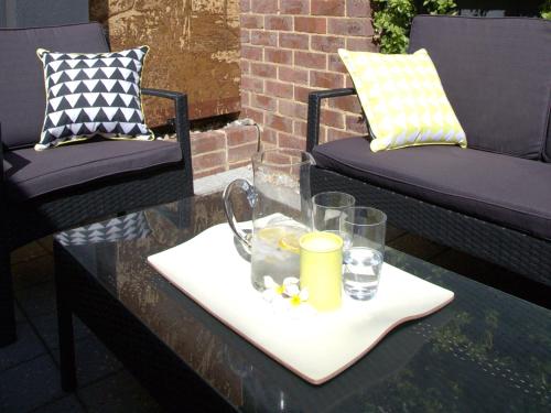 a table with a tray with glasses on it at Haven on the Park in Perth