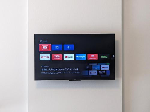 a flat screen tv hanging on a wall at ESLEAD HOTEL Namba South Ⅲ in Osaka
