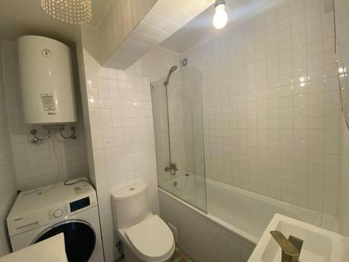 a bathroom with a toilet and a shower and a sink at Vintage Apartment Lastarria in Santiago