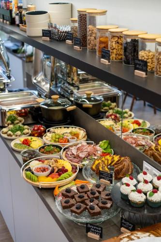 a buffet line with many different types of food at River Apartments in Mladá Boleslav
