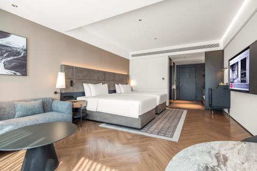 广州广州荔湾城际酒店 LntercityHotel Guangzhou Liwan的配有床和沙发的酒店房间