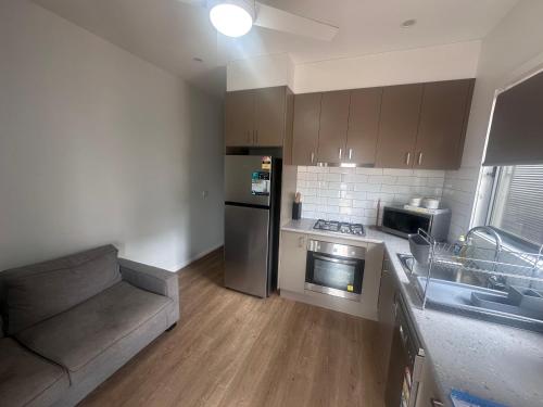 a kitchen with a couch and a stove top oven at Bundalong Villas in Bundalong