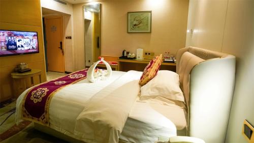 a hotel room with a bed in a room at Dunhuang Hotel in Dunhuang