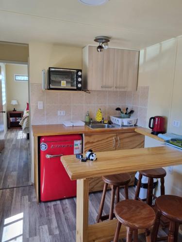 a kitchen with a red refrigerator and wooden counter top at Departamento en Quiriyuca in Puchuncaví