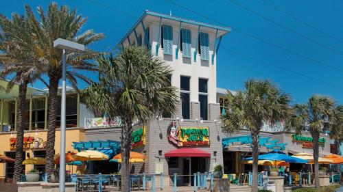 a building with palm trees and umbrellas in front of it at Laketown Wharf 834 in Panama City Beach