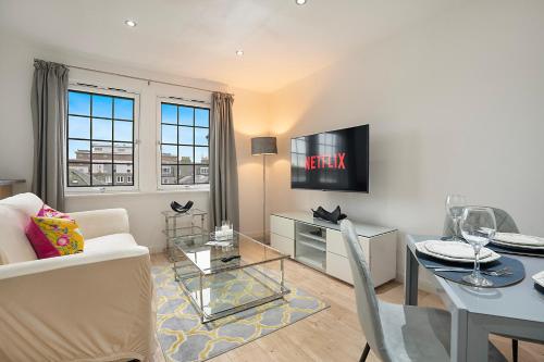 a living room with a couch and a table at George Street Apartment - Grampian Lettings in Aberdeen