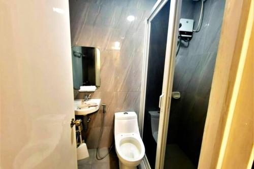 a small bathroom with a toilet and a sink at Treasure Link Cooperative Society DECA CLARK Transient House Angeles City in Angeles