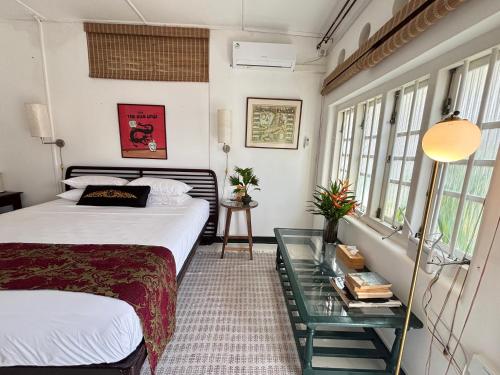 a bedroom with a bed and a glass table at Captain's Lounge- By Prince of Galle in Galle