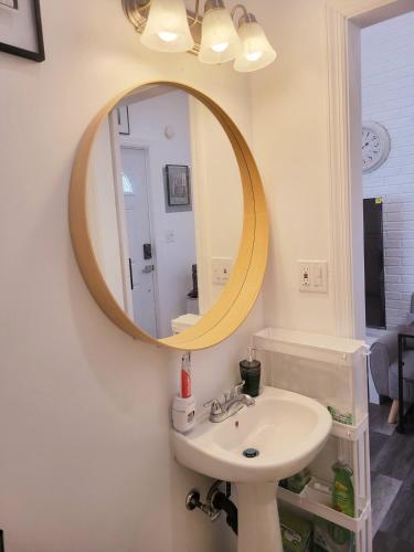 a bathroom with a sink and a mirror on the wall at Private studio guesthouse in Watertown CT in Watertown