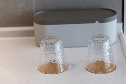 two salt and pepper shakers sitting on top of a counter at Atour Hotel Wefang High Tech Zone Management Committee East Jiankang Street in Weifang