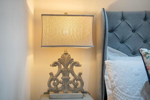 a lamp sitting on a table next to a bed at George Street Apartment - Grampian Lettings in Aberdeen