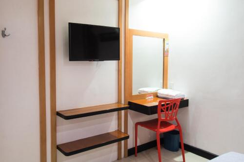 a room with a red chair and a mirror at Hotel Sogo Kalentong in Manila