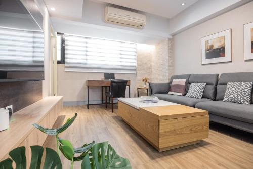 a living room with a couch and a table at 4B2b Clear Comfort 3min to Xinyi Anhe MRT 4房2衛 舒適明亮之家 3分到信義安和站 in Taipei