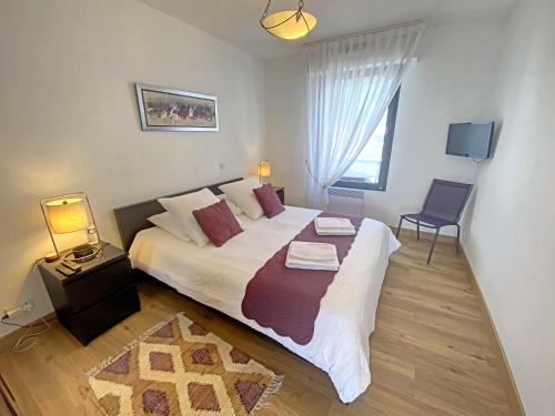 une chambre avec un grand lit blanc et une fenêtre dans l'établissement Penthouse au cœur de Lorient avec terrasses, spa, parking sécurisé et proche des plages - FR-1-349-225, à Lorient