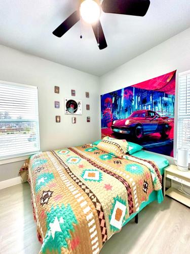 a bedroom with a bed and a car on the wall at Babyproofed, CinemaHome, TCU,DikciesArena,Stockyard,FortWorth in Fort Worth