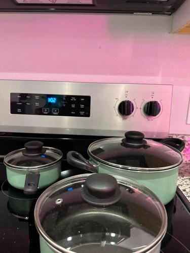 two pots sitting on top of a stove at Babyproofed, CinemaHome, TCU,DikciesArena,Stockyard,FortWorth in Fort Worth