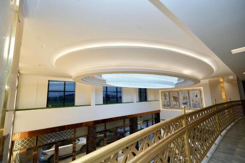 a view of a building hallway with a large light fixture at Le Royale Palace in kāraikāl