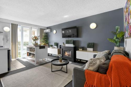 a living room with a couch and a fireplace at Beach-Side Studio Apt with parking spot in Melbourne